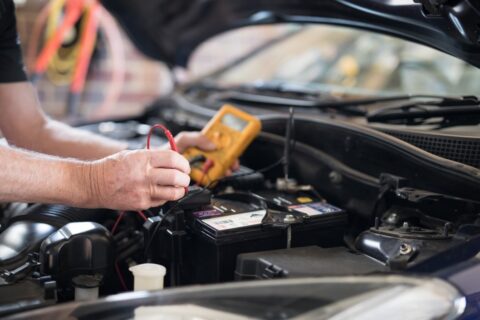a-male-man-senior-mechanic-checking-a-motor-engine-in-a-car-the-battery-tune-up-check-up-oil-change_t20_nLmlKK